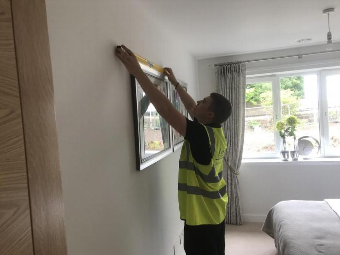 SJP team member installing a picture frame